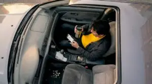 Gig driver checks rideshare app before shift