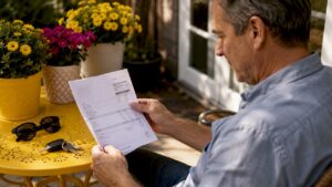 Man reviewing auto repair bill indoors