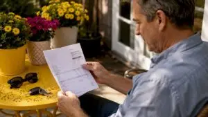 Man reviewing auto repair bill indoors