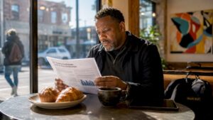 Person reviewing FTC auto pricing report indoors