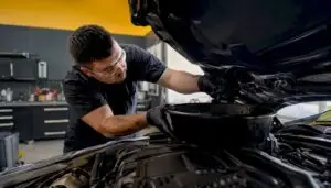 Technician changing BMW engine oil