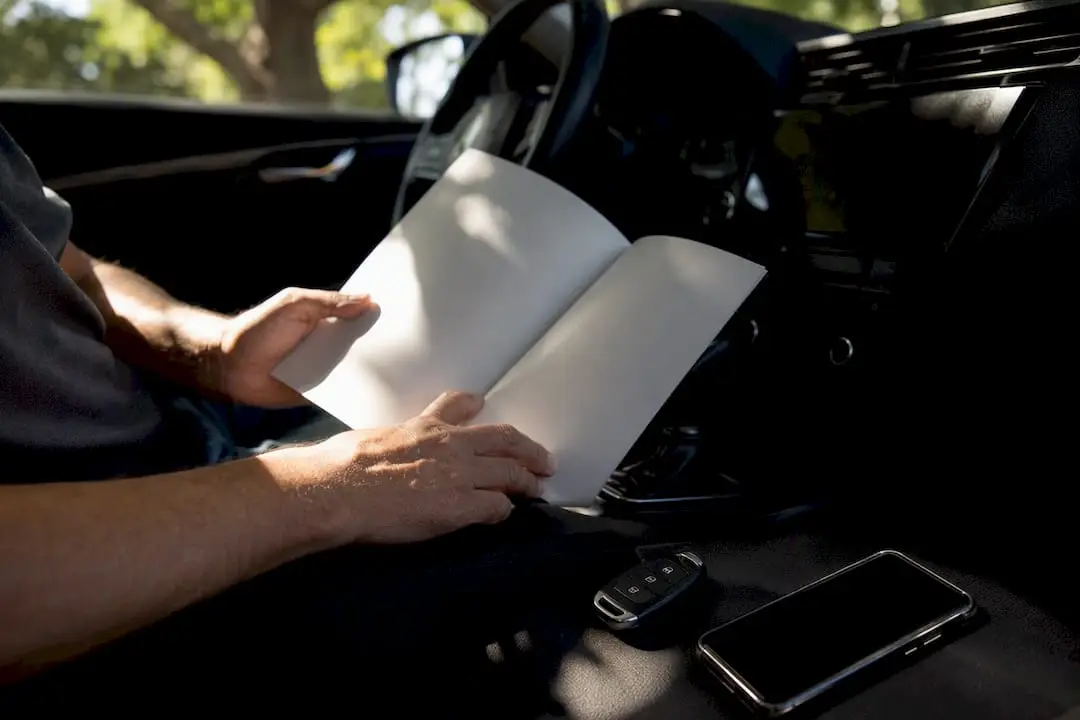 Hands holding blank vehicle maintenance booklet