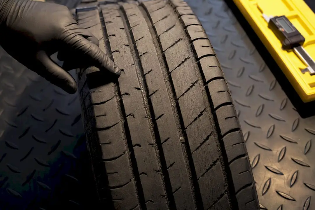 Technician inspecting feathered tire tread