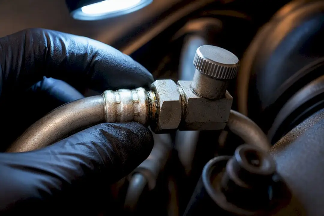 Oily residue around an AC service fitting