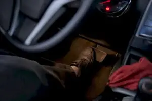 Driver pressing brake pedal during vehicle inspection