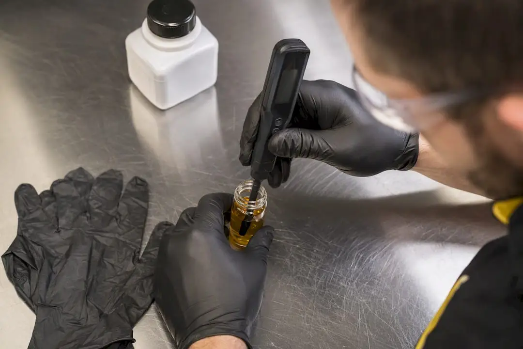 Technician testing brake fluid moisture