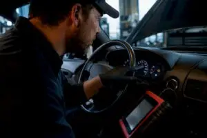 Technician inspecting check engine warning