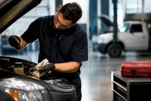 Technician inspecting an anonymous fleet vehicle