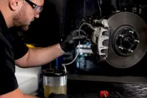 Technician performing a brake fluid flush