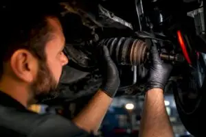 Technician inspecting a CV axle joint