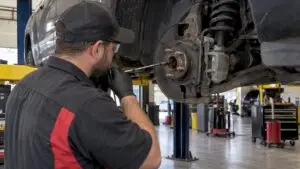 Technician testing a vehicle wheel bearing