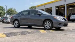 Sedan crossing a parking-lot speed hump