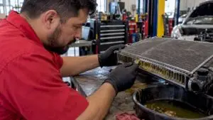 Technician inspecting coolant residue near radiator passages