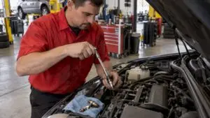 Technician removing a spark plug from an engine